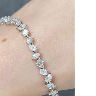 Natural Mix Shape White Diamond Tennis Bracelet In 18k Gold. The bracelet consists of all Fabcy shapes like pear, marquise, Oval , Asscher .