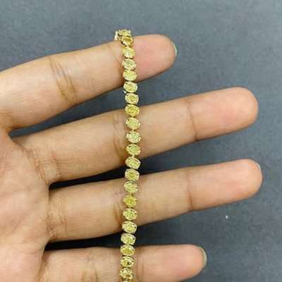 Natural Fancy Yellow Oval Shape Diamond Tennis Bracelet In 18k Yellow Gold.