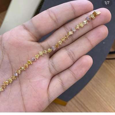 An 18k gold bracelet,this bracelet is set with 44 fancy shaped, fancy color diamonds totaling 5.94ct. 