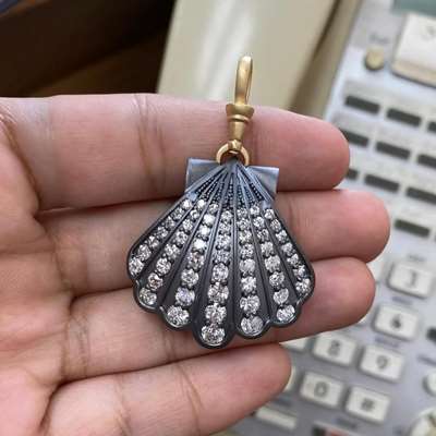 a pearl shell inspired pendant with gradual old cut diamonds