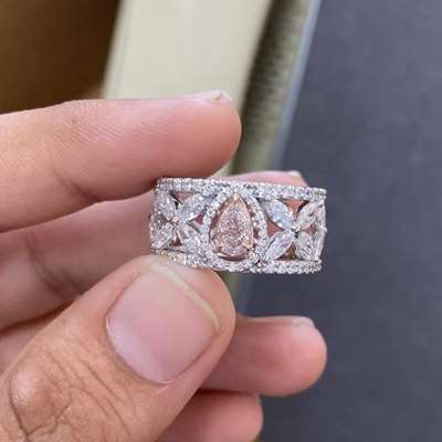 The center is a 0.51ct GIA certified pink pear diamond, Surrounding with it are twelve marquise diamonds arranged like petals