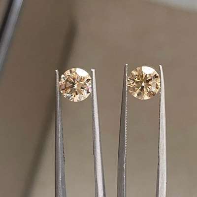 2.04ct total weight matching pair of natural fancy peachy brown VS clarity round brilliant pair