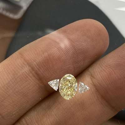 1.01ct GIA Certified Natural Light Yellow (w to x range) VS1 Clarity Oval Shape Diamond Along With 0.16ct Total Weight Matching Pair Of Natural FG Color VVS-VS Clarity Trillion Shape Diamonds