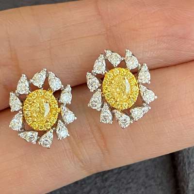 Fancy yellow oval shape diamonds set in 18k gold earrings