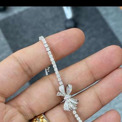 Natural white diamond bow shape tennis bracelet in 18k gold