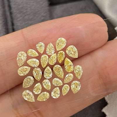 this stunning layout of 26 Natural Fancy Light Yellow Pear Shape Diamonds, totaling 2.56ct. With VS-SI clarity, 