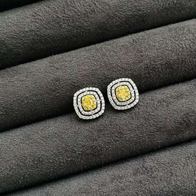 exquisite pair of Natural Fancy Light Yellow Cushion Diamonds, expertly set in 18k gold halo earrings.