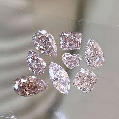 Presenting a gorgeous 8-piece diamond layout. This stunning collection features 2.32ct total weight of Natural Fancy Brownish Pink diamonds, featuring VS-SI clarity and a mix of fancy shapes.