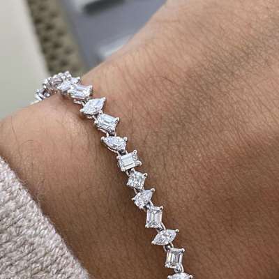 A gorgeous natural white mix fancy shape tennis bracelet in 18k gold