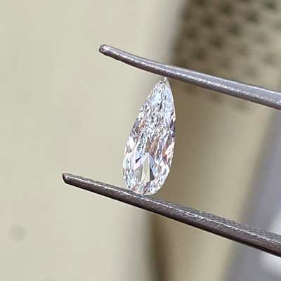 A 0.38-carat, GIA-certified, natural F-color, VVS2-clarity, super long pear-shaped diamond.