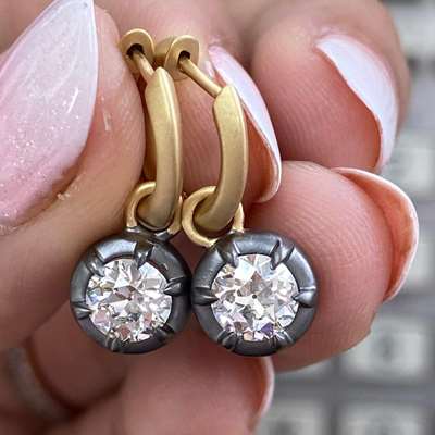 A gorgeous pair of GIA Certified natural J color VVS2 Clarity old cut round shape diamonds set in 18k gold earrings