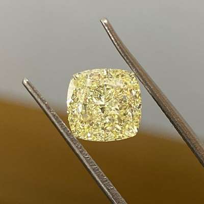 3.12-carat GIA-certified Natural Light Yellow (W-X range) diamond is a true showstopper, featuring a beautiful cushion shape and exceptional VVS1 clarity