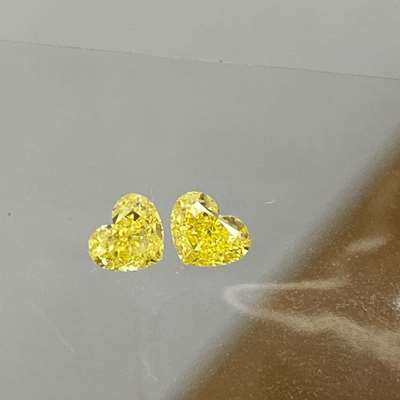 0.61cts total weight pair of natural fancy intense yellow VVS2 clarity heart shape diamonds