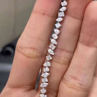 - Natural white mix shaped diamonds in 18k white golf tennis bracelet.