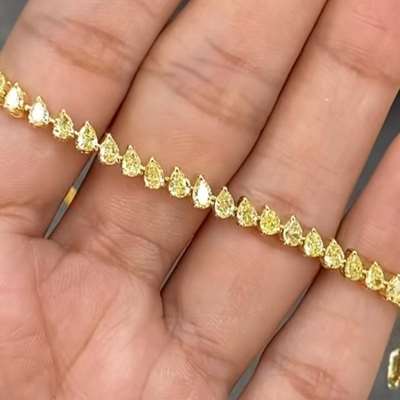 Natural Fancy Yellow colour pear shaped diamonds set in 18 K Yellow gold Tennis bracelet