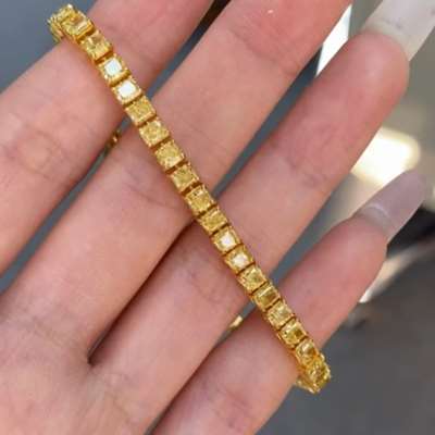 7.35CTS Natural Fancy Yellow Radiant Cut Diamond Tennis Bracelet in 18k Gold.