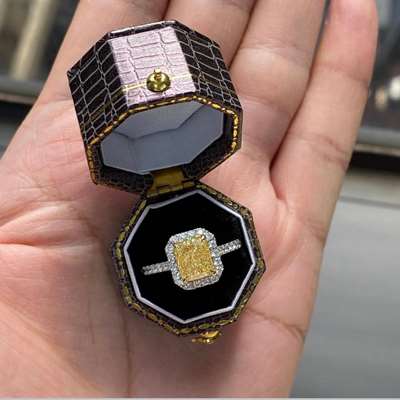 2.03ct GIA Certified Natural Light Yellow (w to x range) VS1 Clarity Long Radiant Set In 18k Gold With White Diamond Halo around.