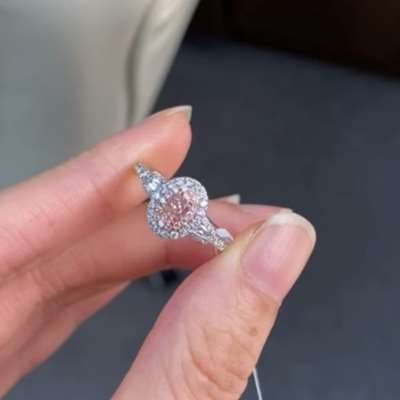 A GIA Certified 0.30ct in Fancy Light Orangy Pink, VS1 clarity, Oval shape