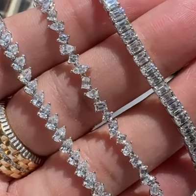 Natural white diamond emerald cut tennis bracelet in 18k white gold.