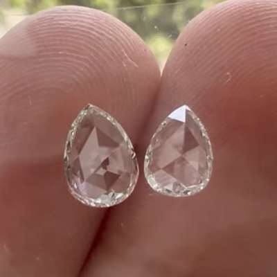 A 0.91cts total weight pair of natural HI color VS2 clarity rosecut pear shape diamonds