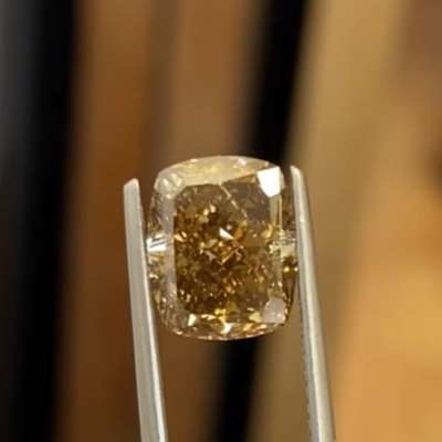 A 3.52cts natural dark brown VS1 clarity cushion shape diamond with a rich, intense color that instantly pulls you in.
