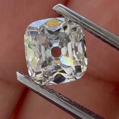 A 1.01ct GIA natural K color, faint brown VS2 old cut cushion.