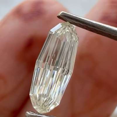 A 0.57cts GIA certified natural J color VVS1 clarity oval step cut diamond.