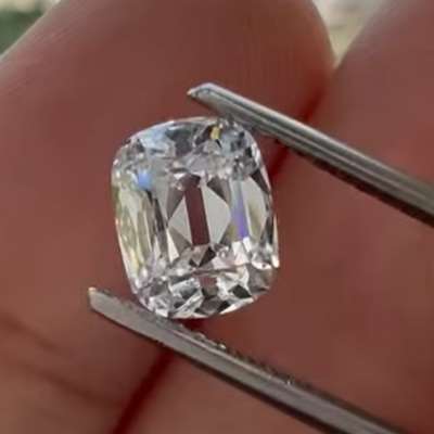A 1cts natural E color VVS2 old cut cushion shape diamond.