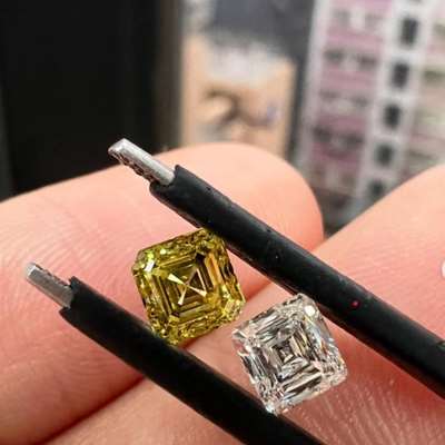  0.60ct Natural Fancy Intense Yellow VVS1 Asscher Diamond alongside a 0.41ct Natural D VVS2 Scissor Cut Diamond.