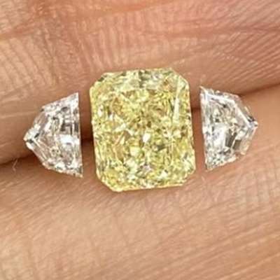  1.09cts GIA Certified Light Yellow (W-x range) VVS2 clarity Radiant Shaped Diamond paired with 0.35cts total weight pair of FG color VVS-VS clarity Cadillac Shaped shoulder stones