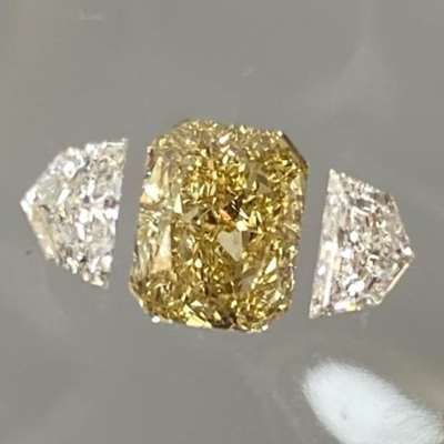 1.15cts Natural Fancy Brownish Yellow Radiant Shape Diamond paired with the 0.41cts E color VVS2 clarity Cadillac Shape shoulder stones 
