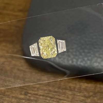 1.01ct GIA Certified Natural Light Yellow (w to x range) VVS2 Clarity Long Radiant Along With Matching Pair of 0.23ct Total Weight Trapazoid Shape Diamonds FG Color VVS-VS Clarity For 3 stone Ring Layout.