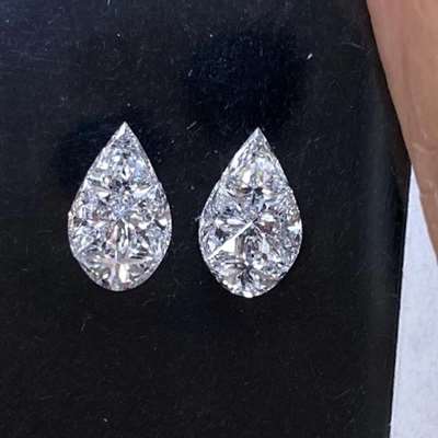 This stunning pair of illusion-cut pear shape diamonds totals 0.73 carats, featuring natural G color with VVS-VS clarity