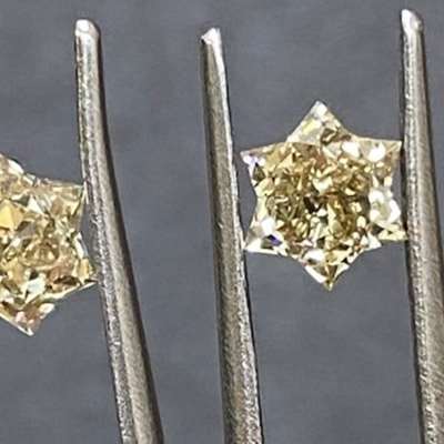 this 0.95 carat total weight pair of natural champagne brown diamonds is cut into the most charming of silhouettes: perfect star shapes. Each diamond glimmers softly in VS clarity