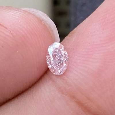 This 0.25ct GIA certified natural fancy orangy pink oval SI1 clarity 