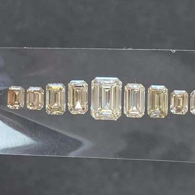  4.56ct layout of 9 natural peachy brown emerald cut diamonds  VVS–VS clarity