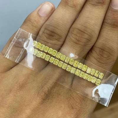 5.58cts total weight of Natural Fancy Yellow radiant cut diamonds, VS to SI clarity, arranged in a set of 34 pieces. 