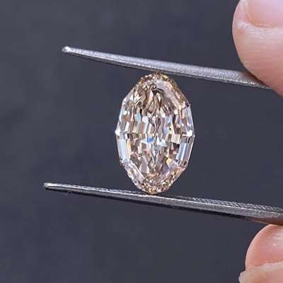 A 2.13 carat natural light peachy brown step cut oval diamond with VS1 clarity and the most graceful, elongated silhouette.