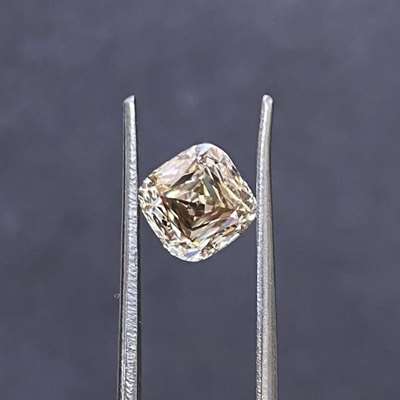This 1.50 ct peachy brown cushion VS2 clarity with a rare scissor cut creates a living pattern inside it.