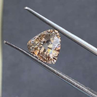 A 0.97 ct old cut triangle diamond, SI2 clarity with brown tone that feels bold, artistic, and full of character. 