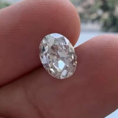 A 1.59ct GIA certified natural K color, faint brown oval old cut diamond with VS2 clarity