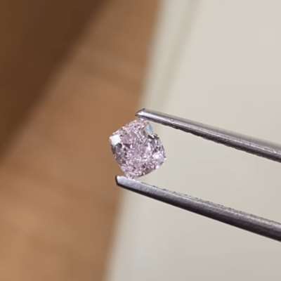 A 0.43ct GIA certified natural fancy light pink cushion with SI2 clarity,