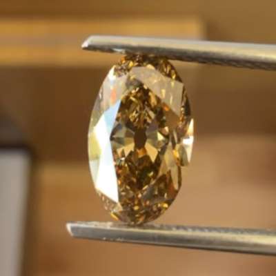 A 1.51ct natural brownish greenish yellow oval old cut with VS1 clarity