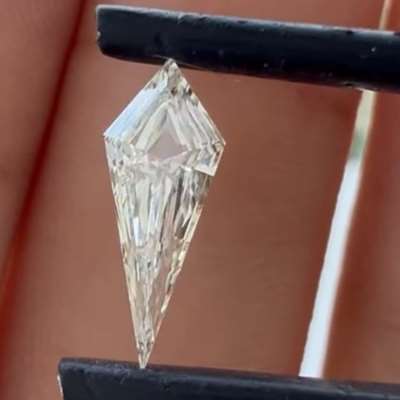 A 0.50cts GIA certified Natural J color VVS2 clarity step cut kite shape diamond with a striking elongated form