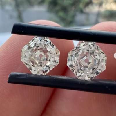 A 1ct GIA certified natural L color (faint brown) VVS2 clarity Asscher cut diamond paired with a 1ct natural L color VS1 clarity Asscher cut diamond