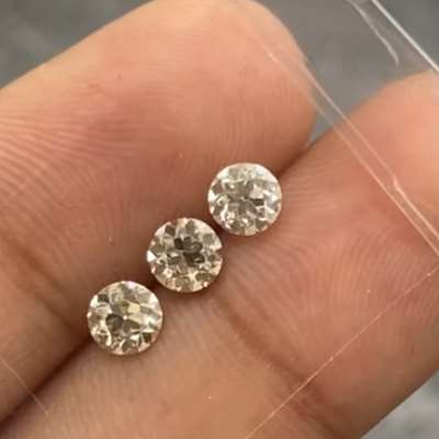  set of three natural old cut round diamonds, featuring a rich brown hue and crisp VS1 clarity.