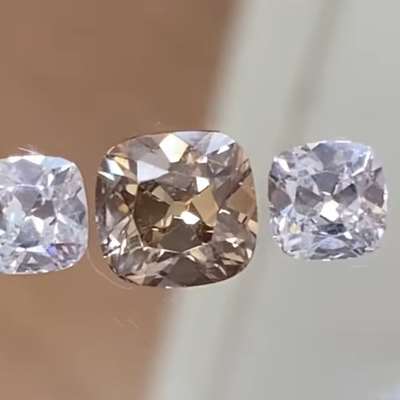 A gorgeous layout of 1.39cts Natural brown VVS2 clarity old cut cushion shape diamond paired with 1.05cts total weight pair of GIA certified Natural H color VVS2 clarity old cut cushion shape diamonds
